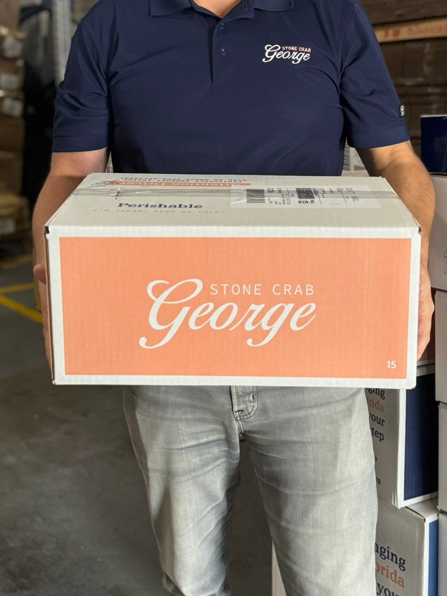 man holding a george stone crab box
